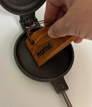 Load image into Gallery viewer, scraping tool being used on round pie iron