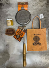 Load image into Gallery viewer, Chuckwagon Waffle Iron Gift Set Bundle from Rome, including cast iron waffle iron, storage cover, seasoning oil, and cleaning brush, displayed on a gray surface - view 2