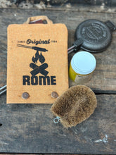 Load image into Gallery viewer, Round Pie Iron & Seasoning Bundle from Rome, including round pie iron, storage cover, seasoning oil, and cleaning brush, displayed on a gray surface - closeup view 4