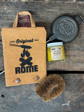 Load image into Gallery viewer, Round Pie Iron & Seasoning Bundle from Rome, including round pie iron, storage cover, seasoning oil, and cleaning brush, displayed on a gray surface.