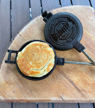 Load image into Gallery viewer, Round Pie Iron unhinged with toasted sandwich wood background