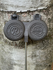 Double round pie iron against tree