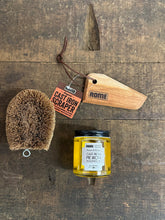 Load image into Gallery viewer, cast iron cleaning tools including brush, wood scraper and seasoning oil shown on wood table