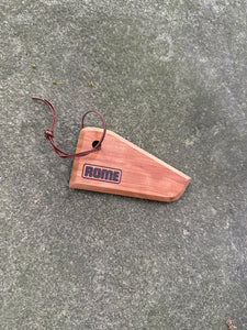 Cast iron cookware wood scraper shown on rock